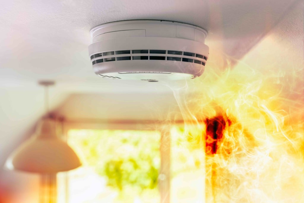 Home Smoke Alarm In Ceiling With Smoke And Flames