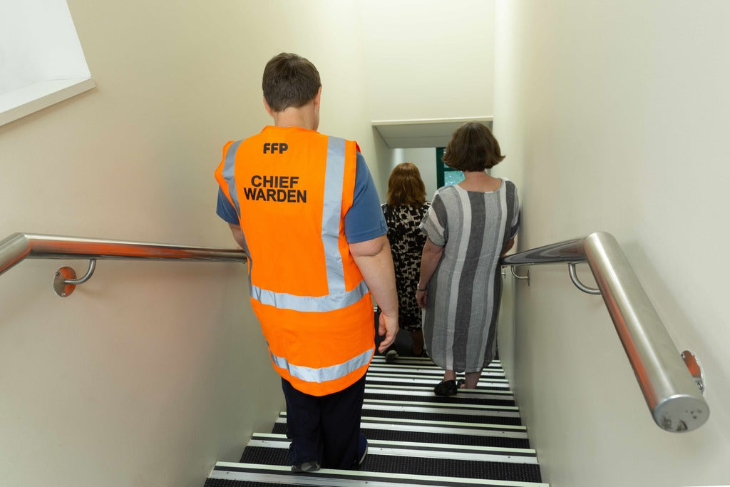 Fire warden assists evacuation in stairwell
